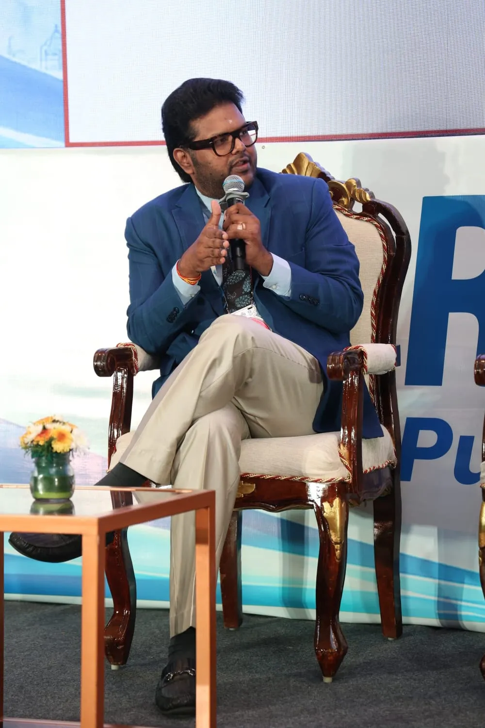 Dr. Koushik speaking during a seated panel discussion.